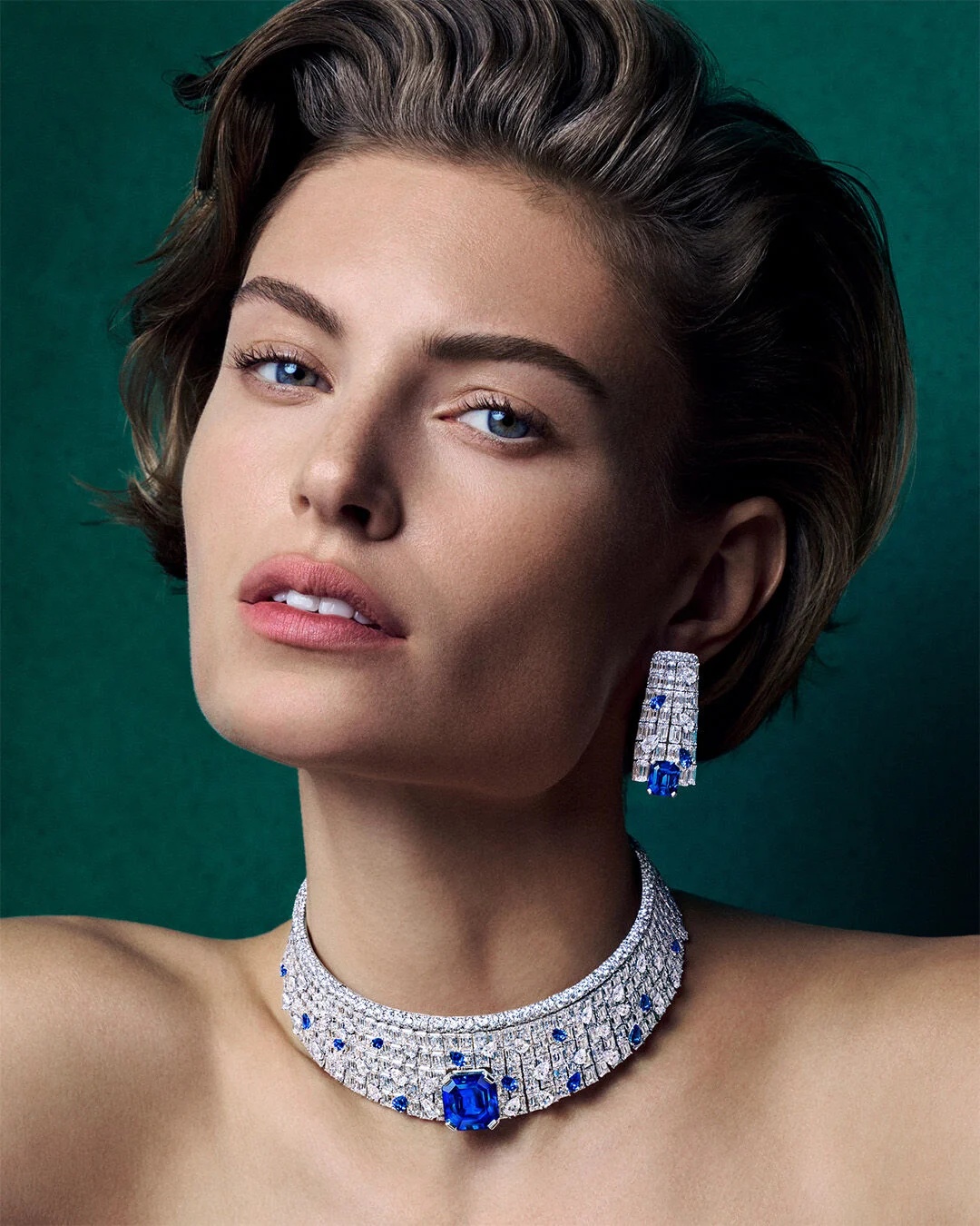 Model wearing an Arvelle sapphire and diamond earring and choker necklace